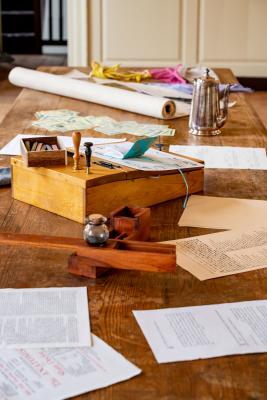 Historical documents and writing implements on a table